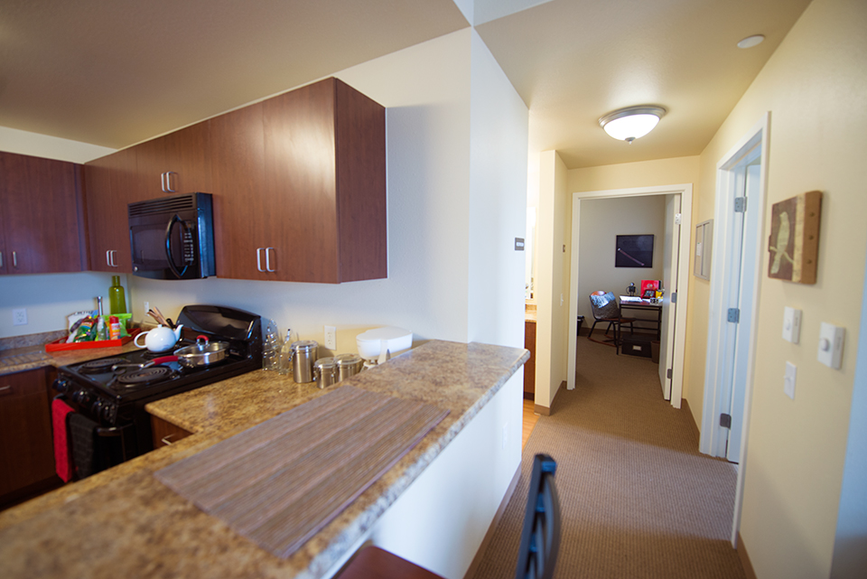 Counter-top of kitchen facing hallway to bathroom and bedrooms. (4x2: 4 single bedrooms & 2 bathrooms).