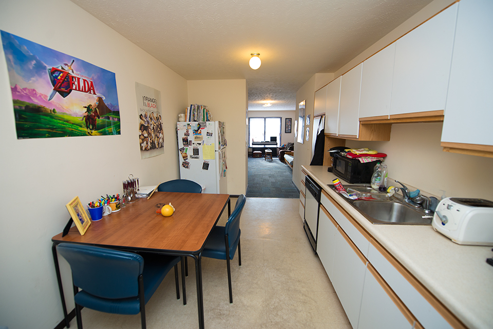 Kitchen facing living room and window
