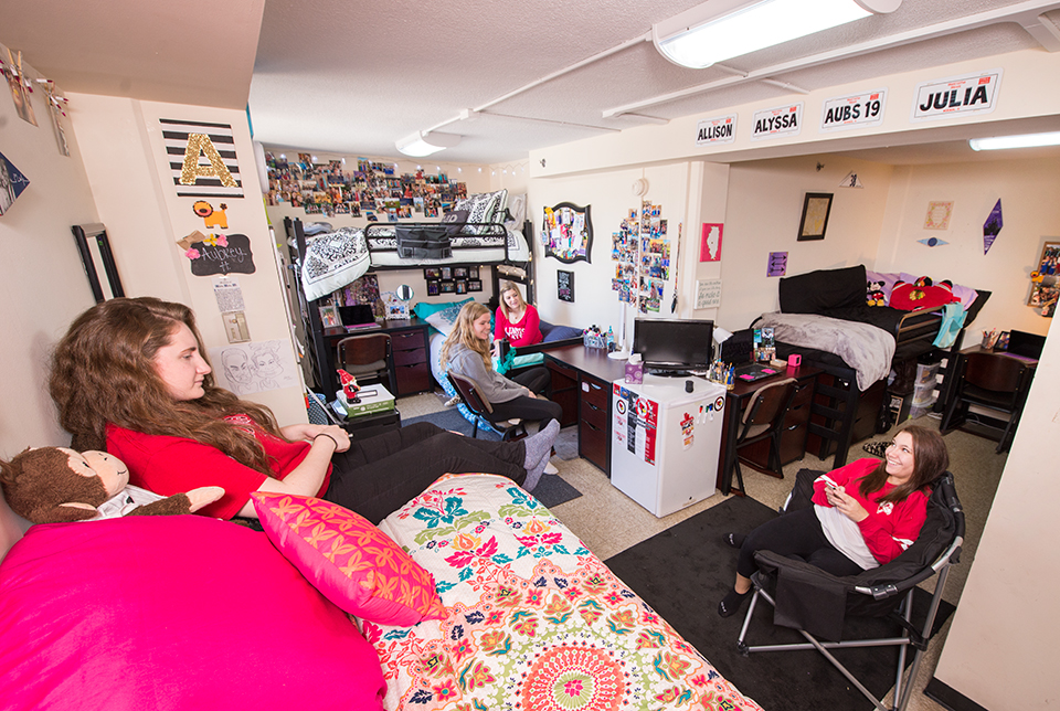 Quad room with beds lofted at varying heights.